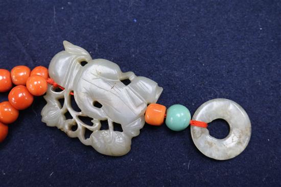 A carved jade, coral and hardstone bead necklace with silver gilt clasp, 32in.
